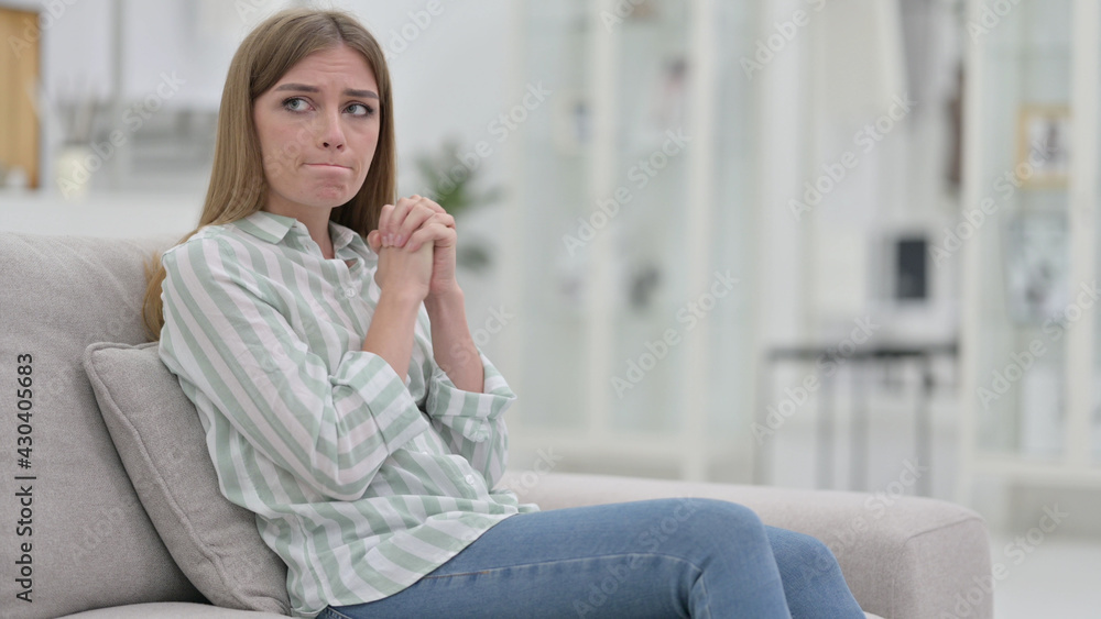 Crying Young Woman Sitting on Sofa, Worried Crying Young Woman Sitting on Sofa, Worried