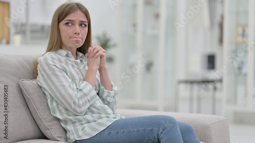 Crying Young Woman Sitting on Sofa, Worried