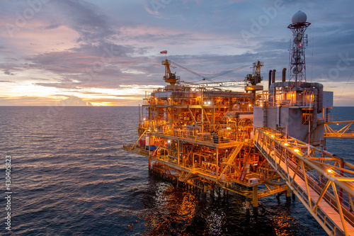 Offshore oil and gas central processing platform in sun set which produce raw gas, crude and hydrocarbon then sent to onshore refine, petrochemical industry. Power and energy business. © Goodvibes Photo