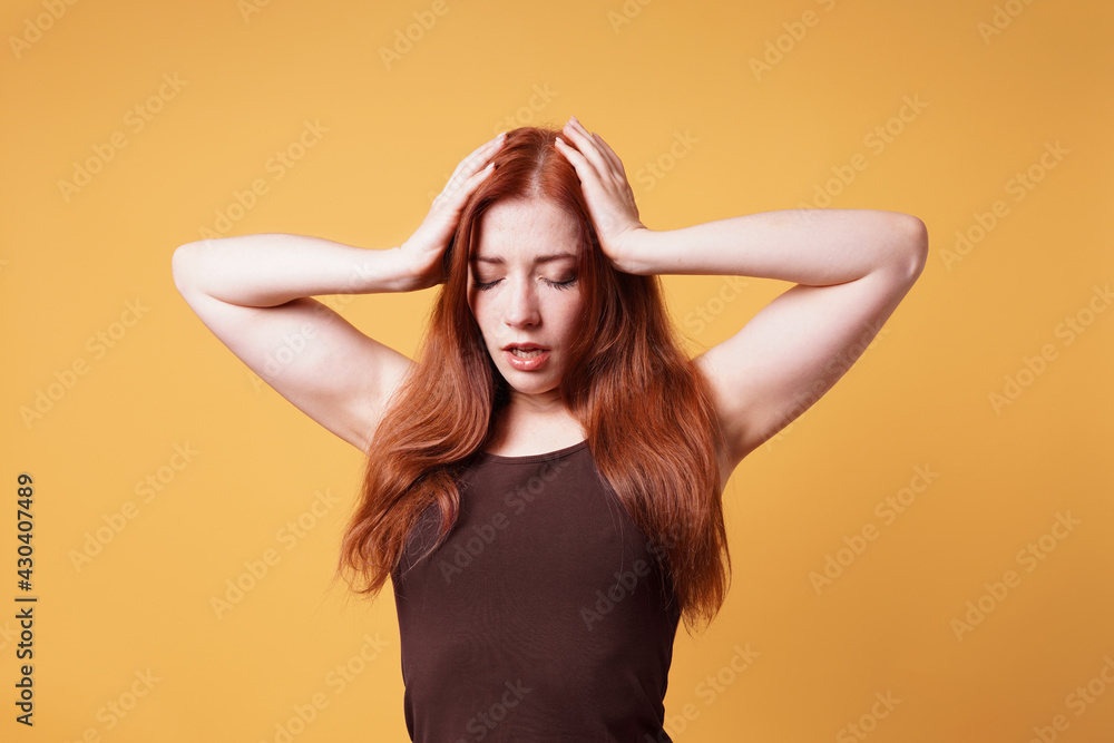Fototapeta premium stressed exhausted young woman holding head suffering from headache or nervous breakdown