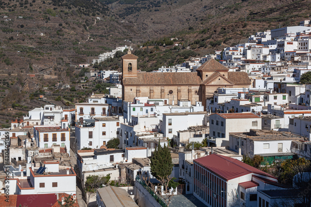 View across white village on the slope of mountain in the Sierra Nevada, Las Alpujarras, Granada Province, Spain