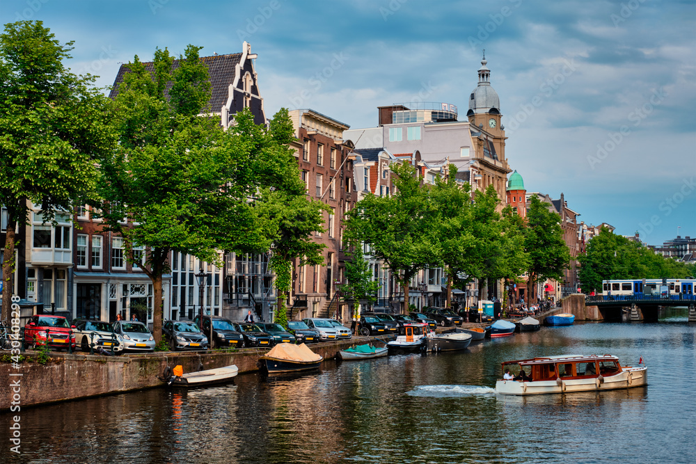 Amsterdam view - canal with boad, bridge and old houses