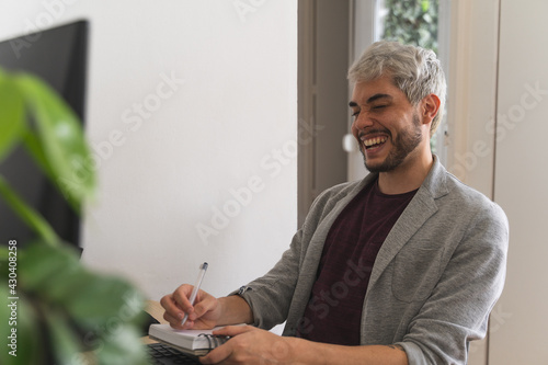 Young man smiling while working from home