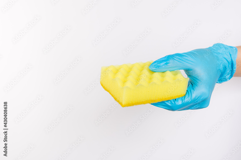 Sponge for washing dishes in female hand. Hand in a latex glove. Woman's hand gesture or sign isolated on white. A hand in a glove holds a sponge for washing and cleaning dishes Sponge for washing dishes in female hand. Hand in a latex glove. Woman's hand gesture or sign isolated on white. A hand in a glove holds a sponge for washing and cleaning dishes