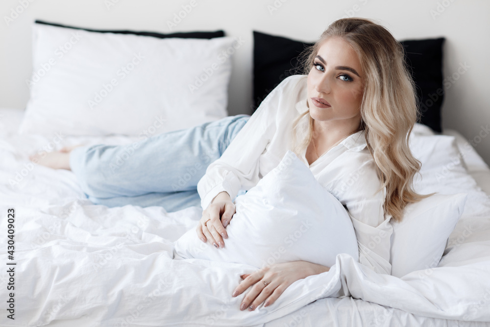 Portrait of a happy young woman indoor on bed Portrait of a happy young woman indoor on bed