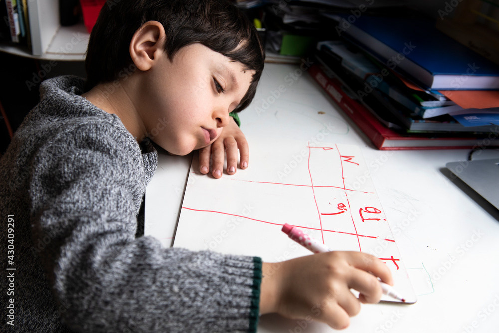 UK, Tired boy doing homework UK, Tired boy doing homework