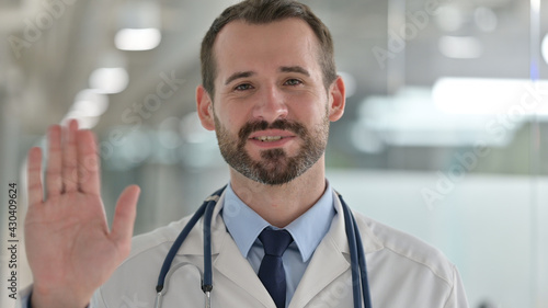 Portrait of Friendly Male Doctor Talking on Video Call  © stockbakers