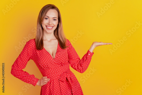 Portrait of caucasian woman hand empty space toothy smile isolated on yellow background