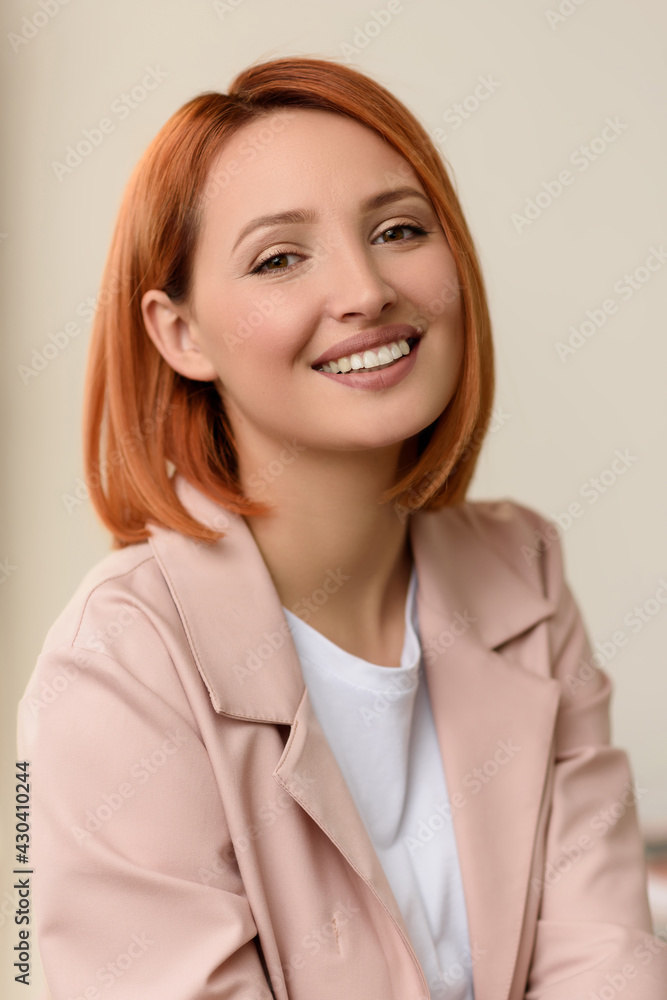 Portrait of a beautiful young happy cheerful cute smiling red-haired business woman in a jacket Portrait of a beautiful young happy cheerful cute smiling red-haired business woman in a jacket
