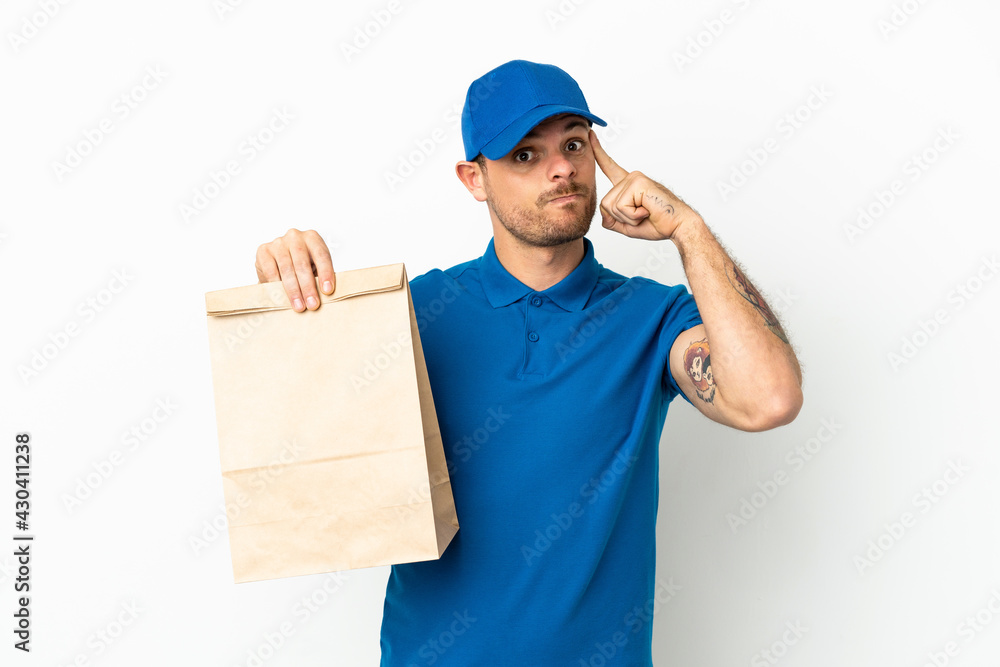 Brazilian taking a bag of takeaway food isolated on white background thinking an idea Brazilian taking a bag of takeaway food isolated on white background thinking an idea