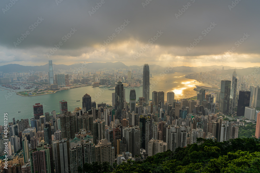 Hong Kong city skyline from Victoria peak, China with dramatic sky.