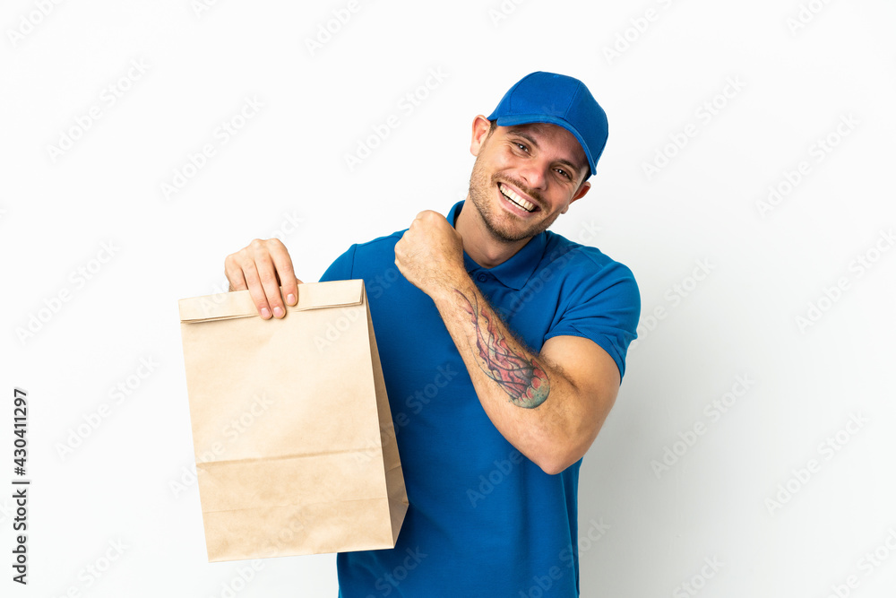 Brazilian taking a bag of takeaway food isolated on white background celebrating a victory Brazilian taking a bag of takeaway food isolated on white background celebrating a victory