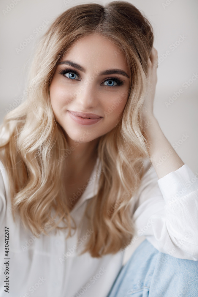 Closeup portrait of a young beautiful blond woman with blue eyes Closeup portrait of a young beautiful blond woman with blue eyes
