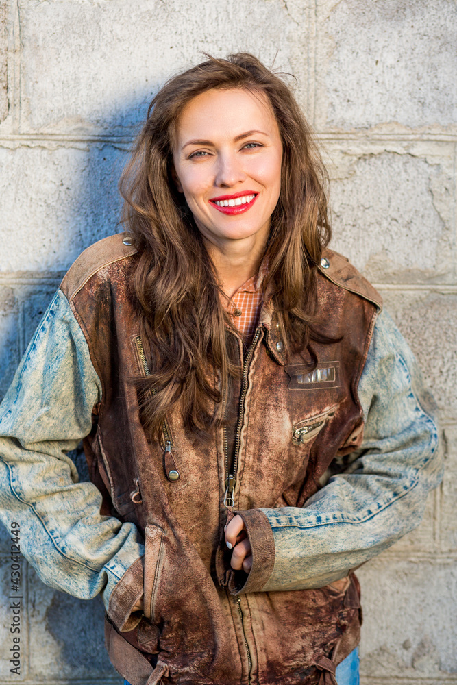 Sexy young woman, outdoor portrait in leather jacket in biker theme Sexy young woman, outdoor portrait in leather jacket in biker theme