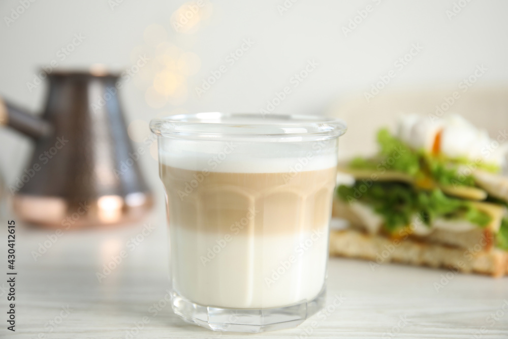 Glass of delicious coffee on white wooden table, closeup Glass of delicious coffee on white wooden table, closeup