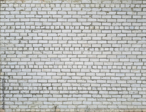 Grey brick wall with traces of destruction and dirty texture