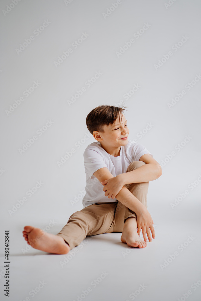 teen boy in white T-shirt pose in a photo studio. problems for teenage boys.  Stock Photo | Adobe Stock