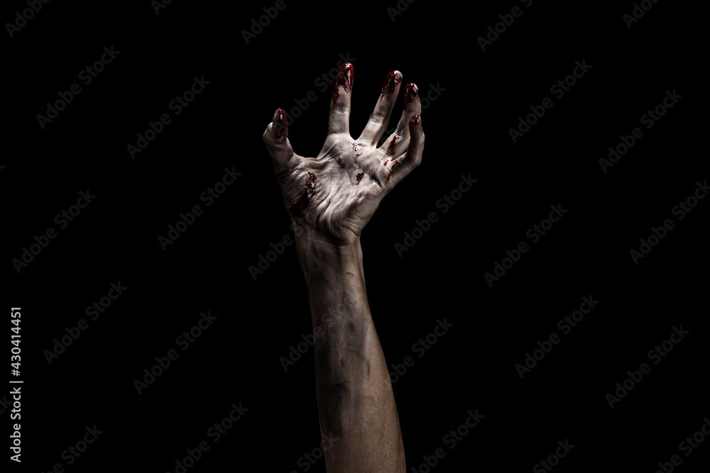 Fototapeta premium Creepy bloody zombie hand over dark background with clipping path. Horror and Halloween theme.