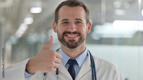 Portrait of Positive Male Doctor showing Thumbs Up Sign 