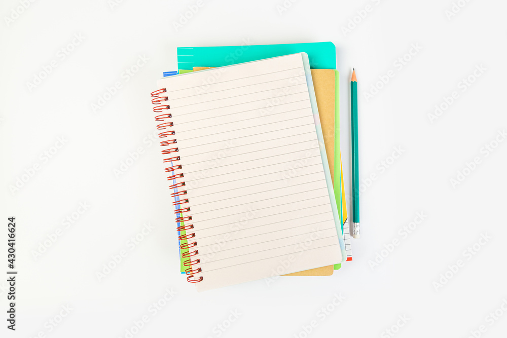 top view of an open notebook with a pencil on a gray background, school notebooks with a spiral spring, office notepad. desktop concept, learning top view of an open notebook with a pencil on a gray background, school notebooks with a spiral spring, office notepad. desktop concept, learning