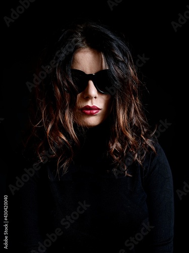 beautiful young woman in black clothes with nice red lips © elabracho