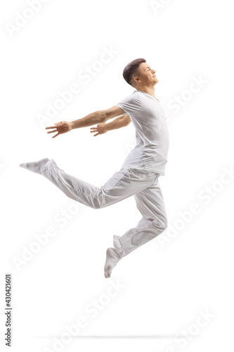 Guy in white clothes dancing a modern ballet