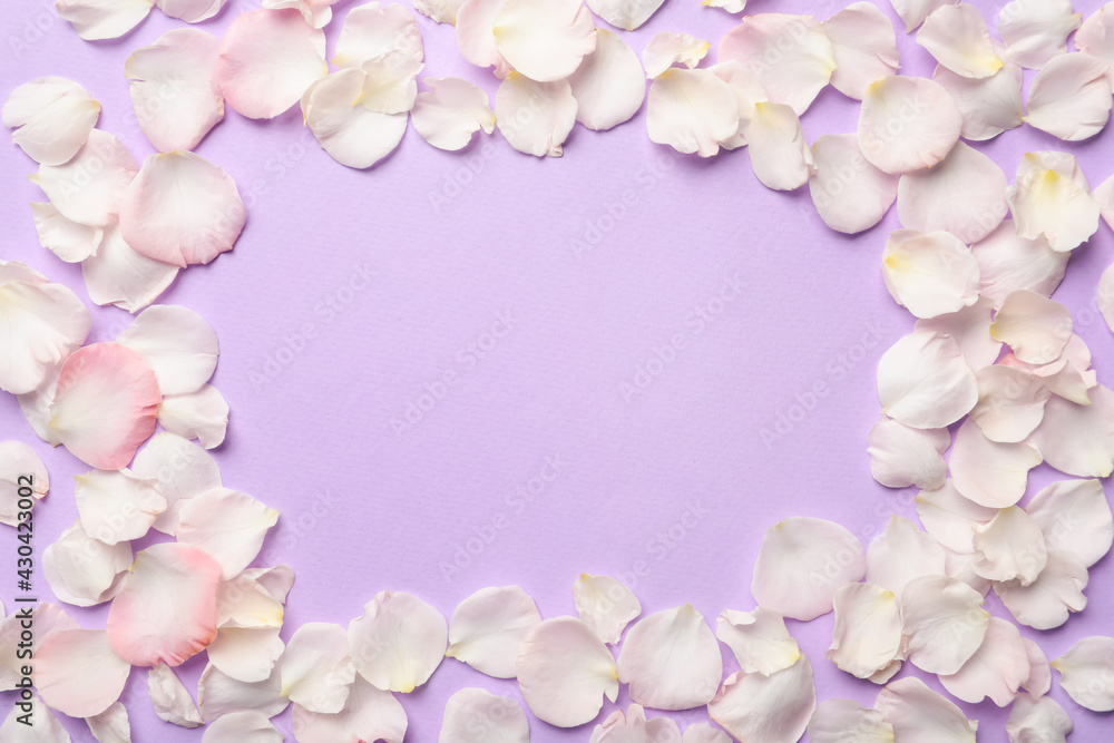 Frame of beautiful petals on lilac background, flat lay. Space for text