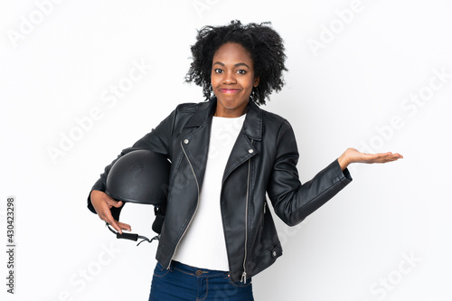 Young African American woman with a motorcycle helmet isolated on white background having doubts with confuse face expression