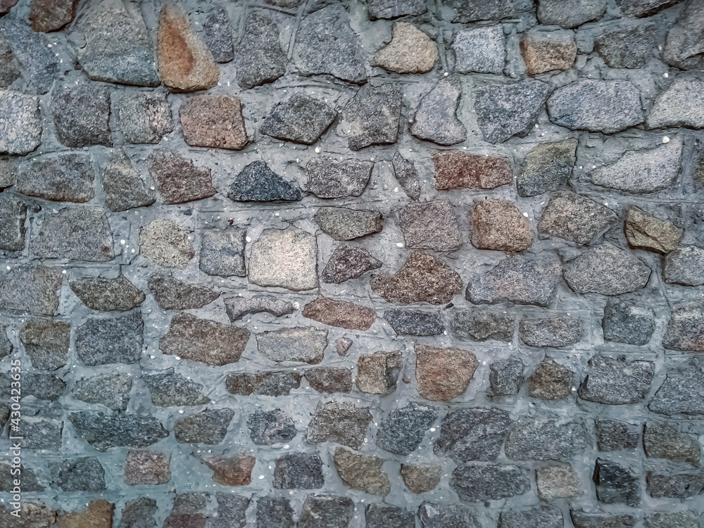 Fototapeta premium Stone wall, made of large stones of different shapes