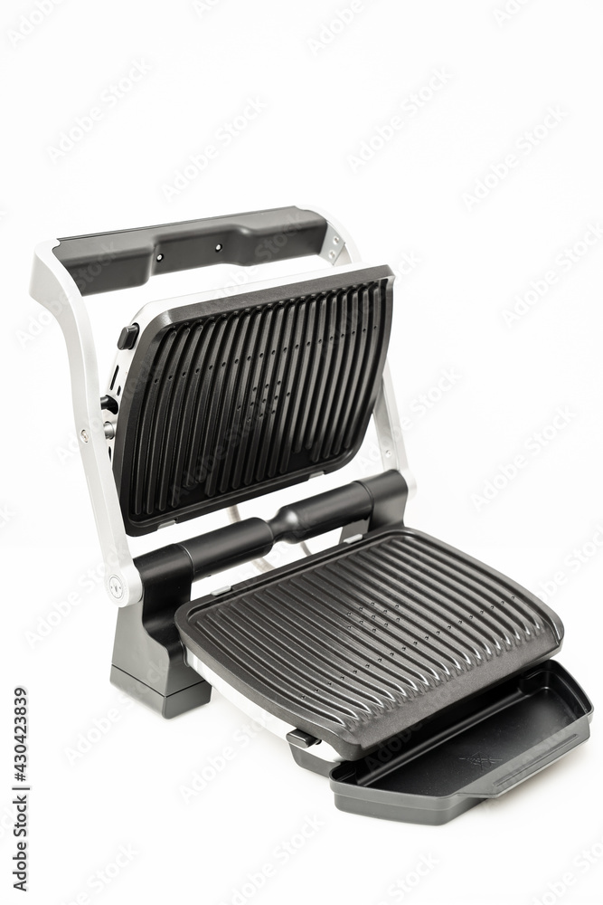 electric grill with open lid. appliance for cooking in everyday life. Made of stainless steel, special non-stick coating. healthy food. food without oil and fat. electric grill with open lid. appliance for cooking in everyday life. Made of stainless steel, special non-stick coating. healthy food. food without oil and fat.