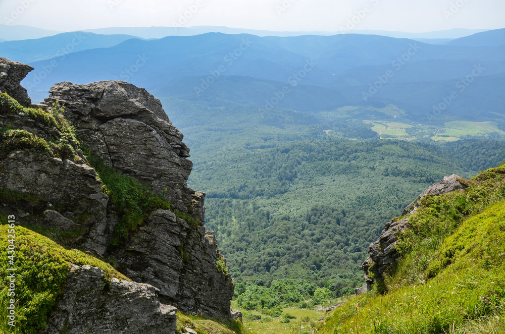 Carpathian mountains with grassy slopes and rocks on Pikuy mount. Beautiful mountain landscape in summer