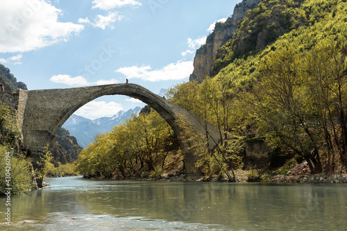 Pedestrian stone bridge Konitsa over river Aoos or Vjose in northwestern Greece, Europe.