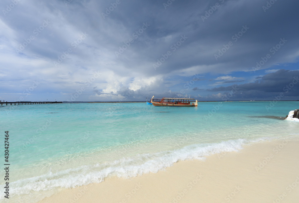 wooden boat floats on a tropical island