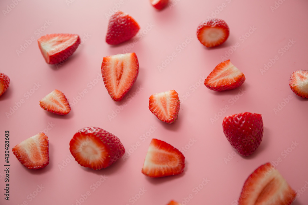 Delicious juicy ripe red strawberries on a pink background. Close-up shot of strawberries on a grater. Berry pattern Delicious juicy ripe red strawberries on a pink background. Close-up shot of strawberries on a grater. Berry pattern