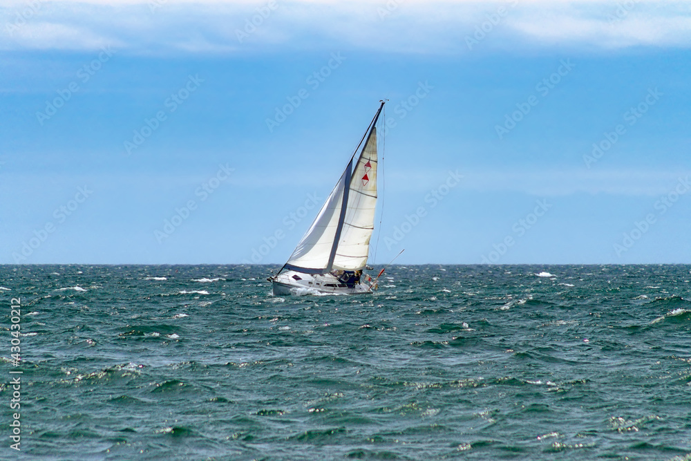 Fototapeta premium Sailboat on the Ontario lake in a windy day (Ontario, Canada).