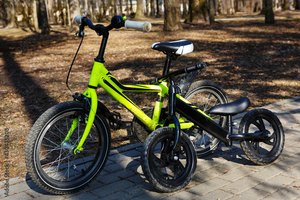 Modern bicycles in a spring park. Healthy active lifestyle. Kid`s bicycle