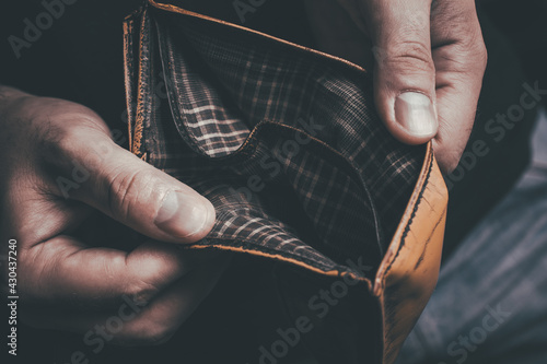 Man Showing His Empty Wallet - No Money Left Concept photo