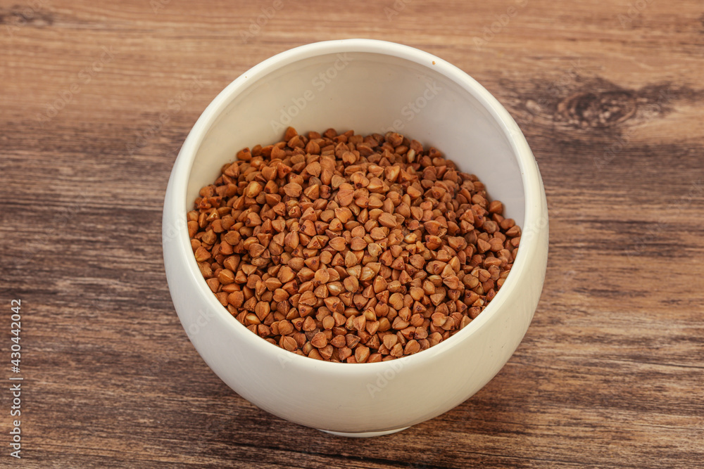 Raw buсkwheat cereal in the bowl Raw buсkwheat cereal in the bowl