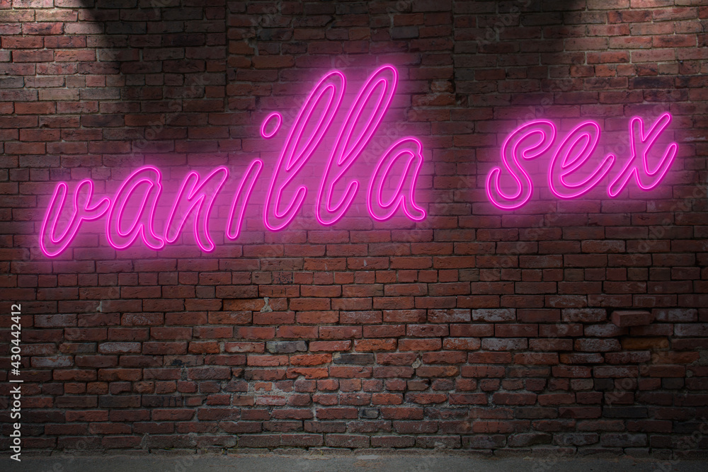 Obraz premium Neon vanilla sex lettering on Brick Wall at night