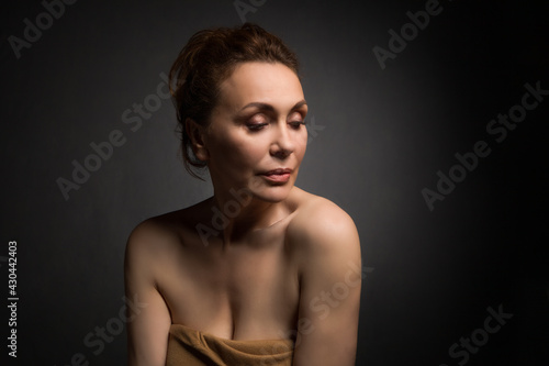 Wallpaper Mural portrait of a sensual fifty year old woman on grey studio background Torontodigital.ca