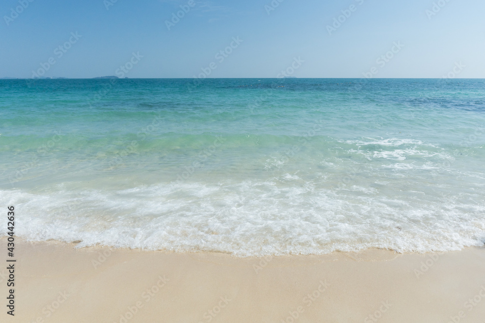 Beach and waves tropical sea with blue sky on sunny day background. copy space..