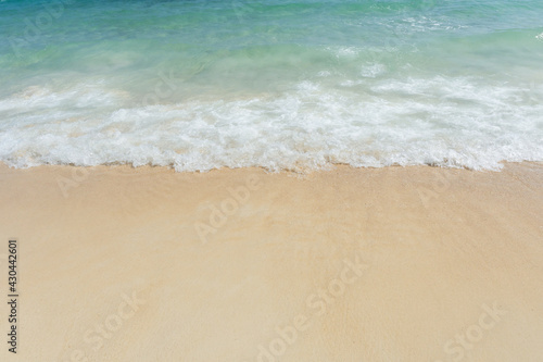 Soft wave of sea on empty sandy beach Background with copy space.