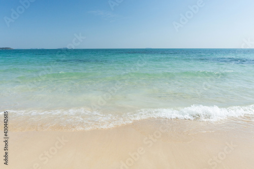 Beach and waves tropical sea with blue sky on sunny day background. copy space.. © Achira22