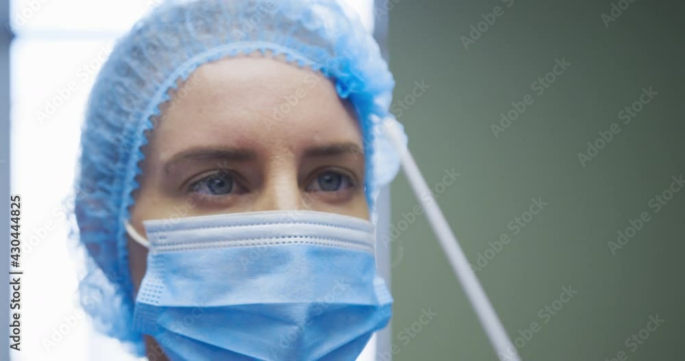 Female caucasian doctor wearing protective clothes reparing covid swab test for patient Female caucasian doctor wearing protective clothes reparing covid swab test for patient