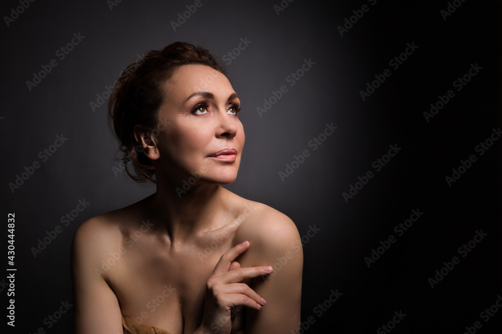 portrait of a sensual fifty year old woman on grey studio background portrait of a sensual fifty year old woman on grey studio background