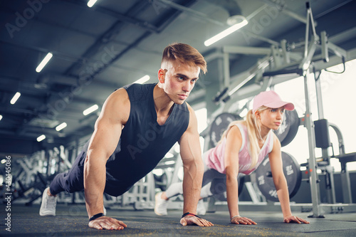 Man and woman strengthen hands at fitness training