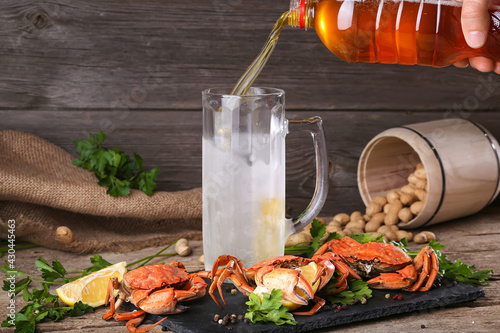 Beer and boiled crabs on a wooden background