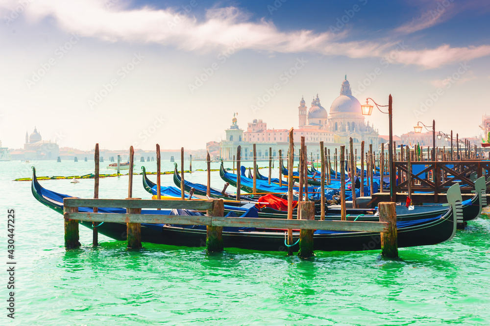 Gondolas on the Grand canal in Venice, Italy. Basilica Santa Maria della Salute in the background. Famous travel destination.