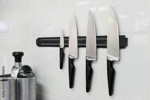 Chef knives with magnetic attachment. Kitchen equipment.