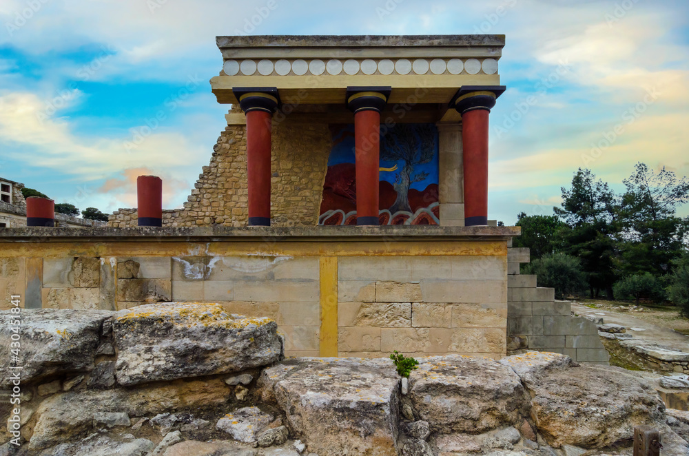 Fototapeta premium Knossos Palace, Crete, Greec.Restored North Entrance with the Charging Bull fresco at the famous archaeological site of Knossos. Sunset, cloudy sky, famous place